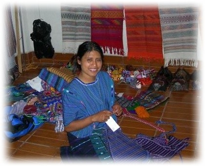 Mayan girl prepares textiles for selling